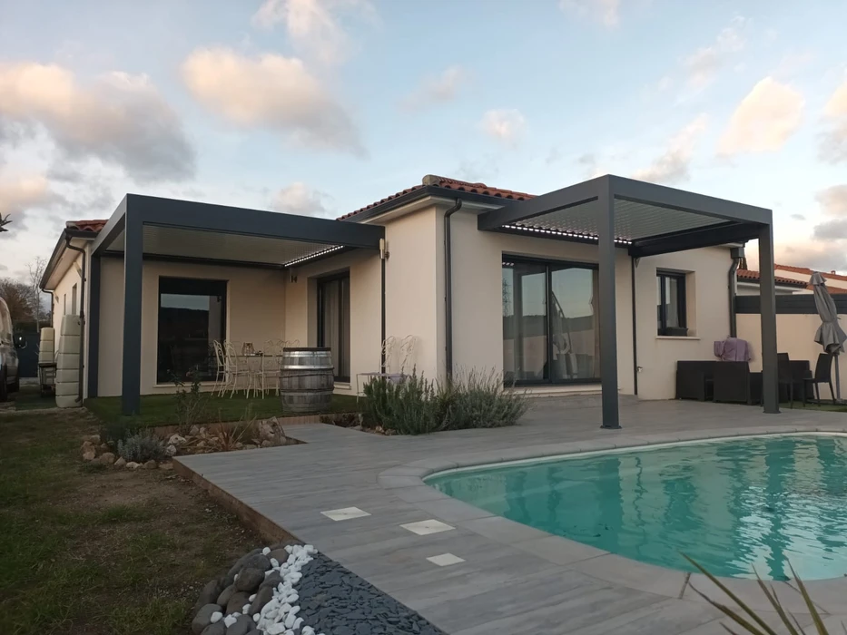 Terrasse extérieure couverte d'une pergola bioclimatique à lames orientables blanches, structure aluminium beige